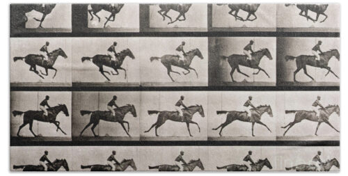 Jockey on a galloping horse Beach Towel