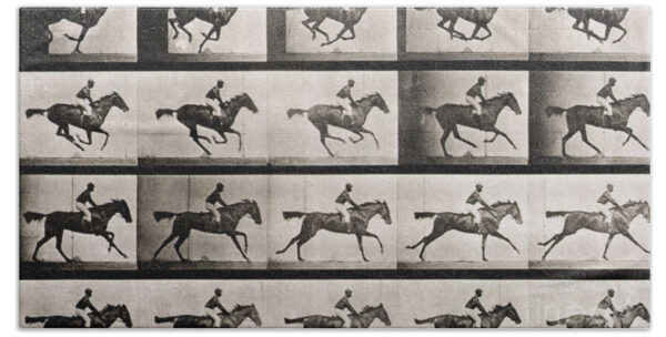 Jockey on a galloping horse Beach Towel